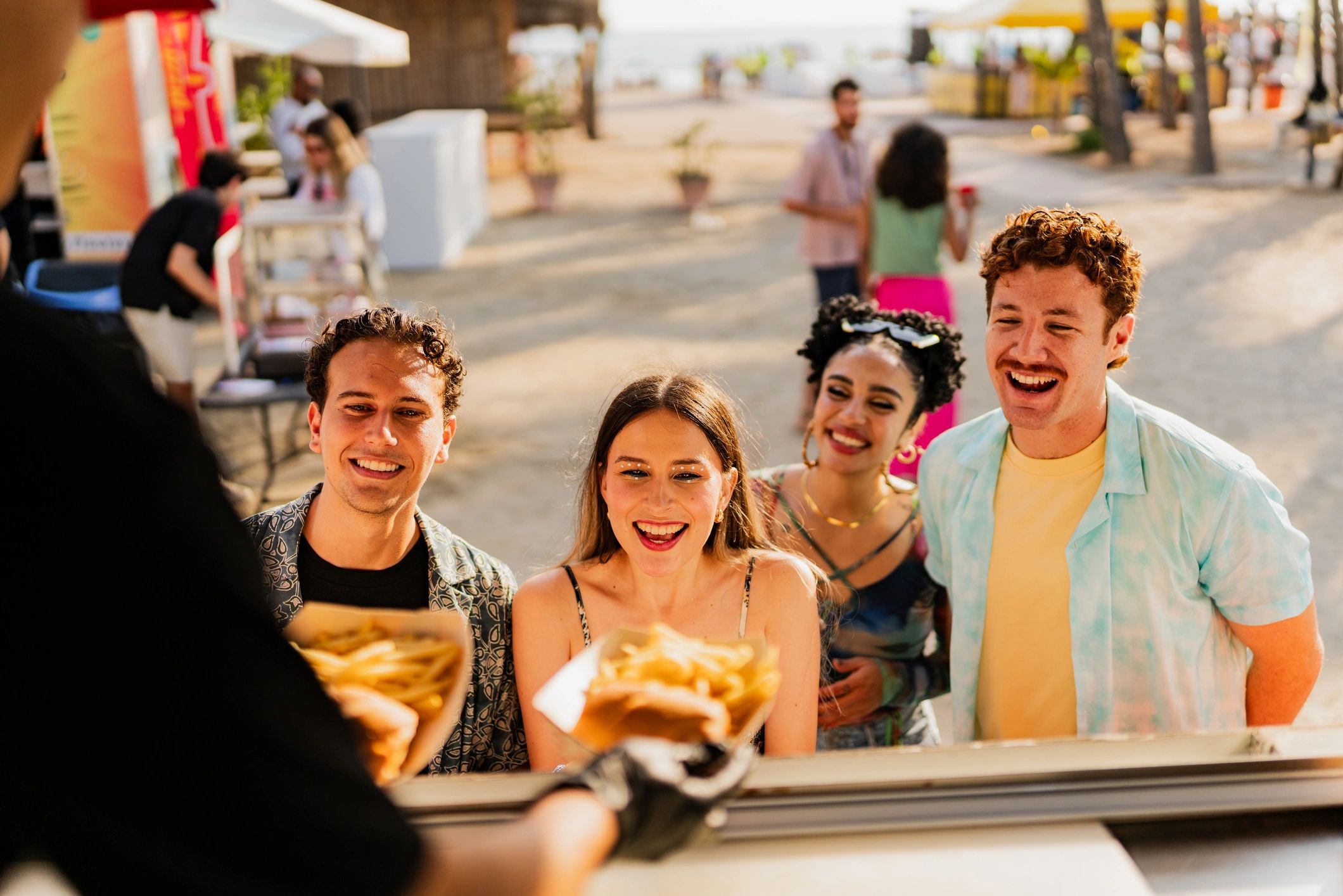 Food truck vendor serving snacks to customers at an outdoor event