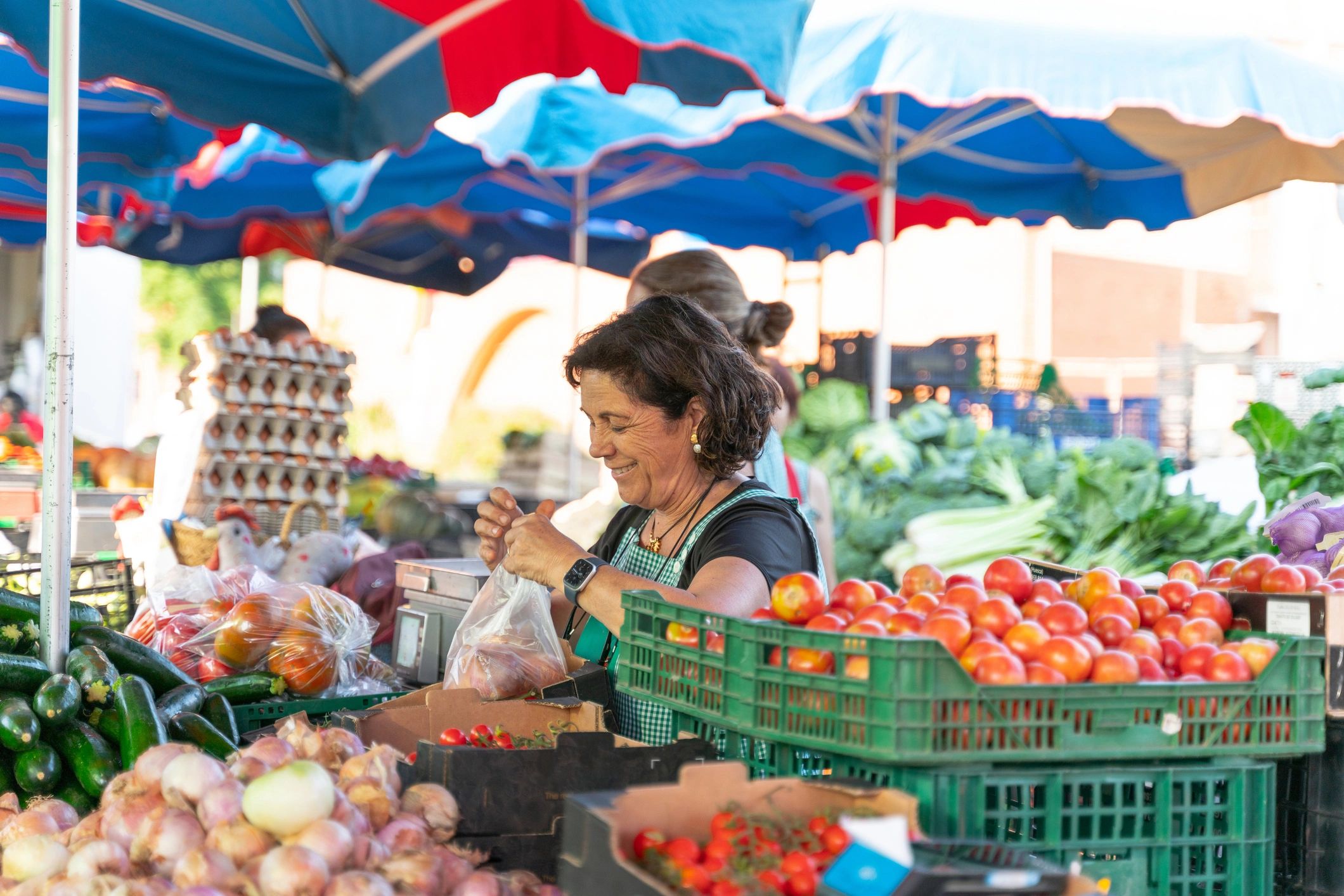 Greengrocer weighing fresh produce at a farmers market