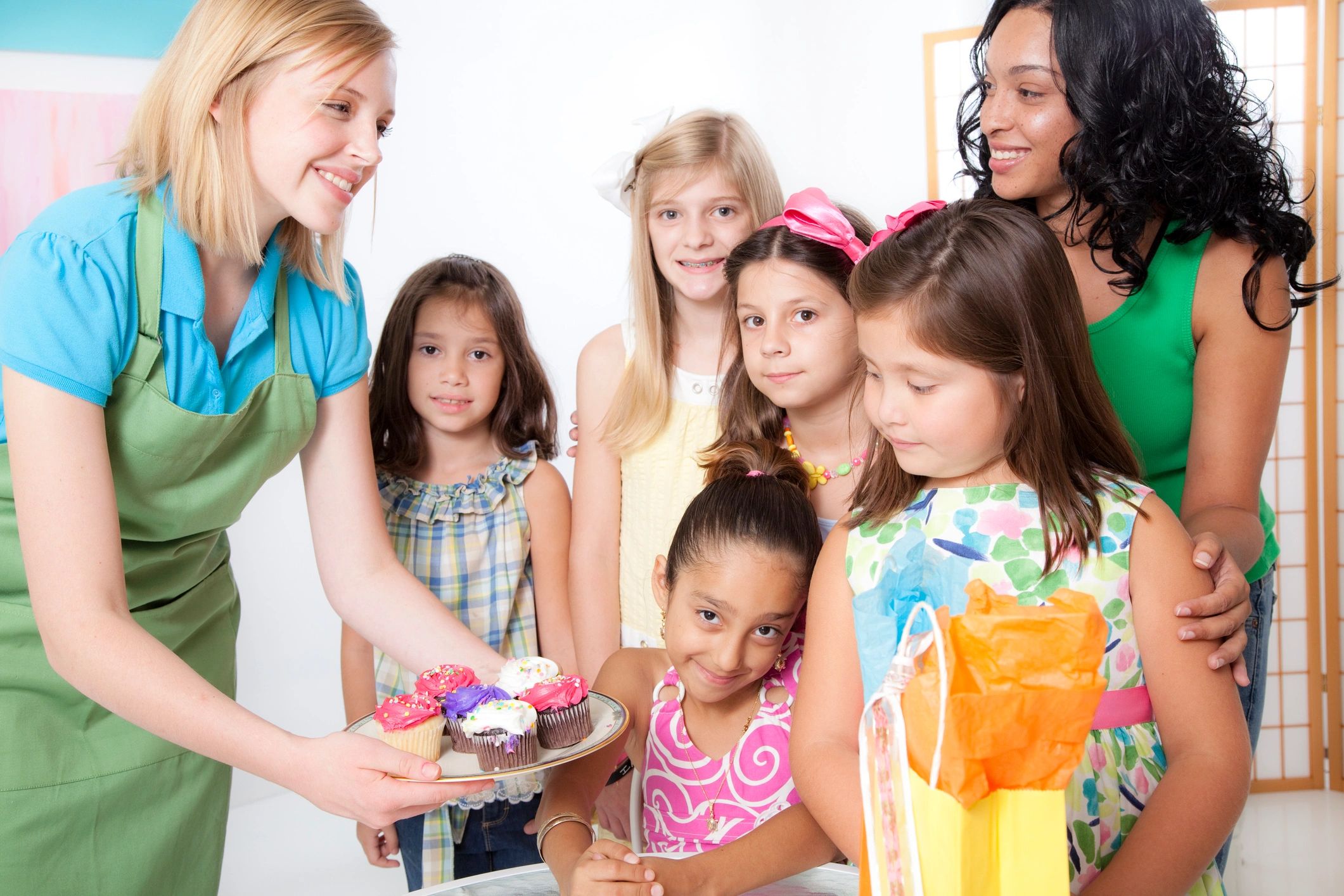 Kids at a birthday party with cupcakes